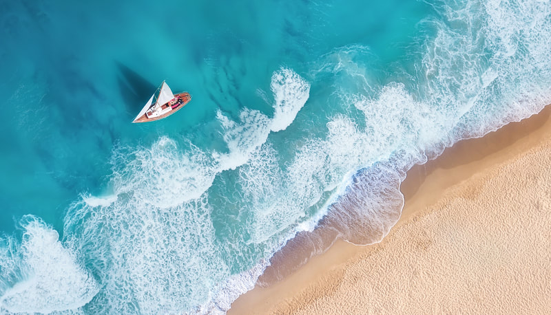 Aerial image of yacht by beach